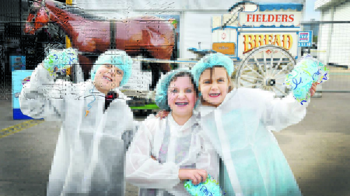 END OF AN ERA: Jack, 8, Isabelle, 11, and Lilly Large, 6, stock up on fairyfloss at the Buttercup Bakery’s family fun day before it closes down this week. Photo: Barry Smith 260616BSC04