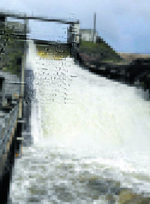 THA' SHE BLOWS: Dungowan Dam provided some spectacular scenes as water shot over the spillway early yesterday, signalling the water supply was at capacity. Photo: Adrian Cameron