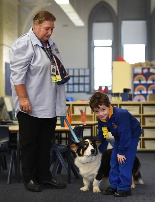 MAKING FRIENDS RESPONSIBLY: Jacqueline Roper and Ghost, of the Responsible Pet Program, with Tamworth Public School’s Chase Prout. Photos: Gareth Gardner 020616GGA01