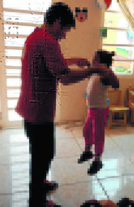 LEFT – MOVING: Mr Moffatt and student Favi have a dance together at the special-needs school.