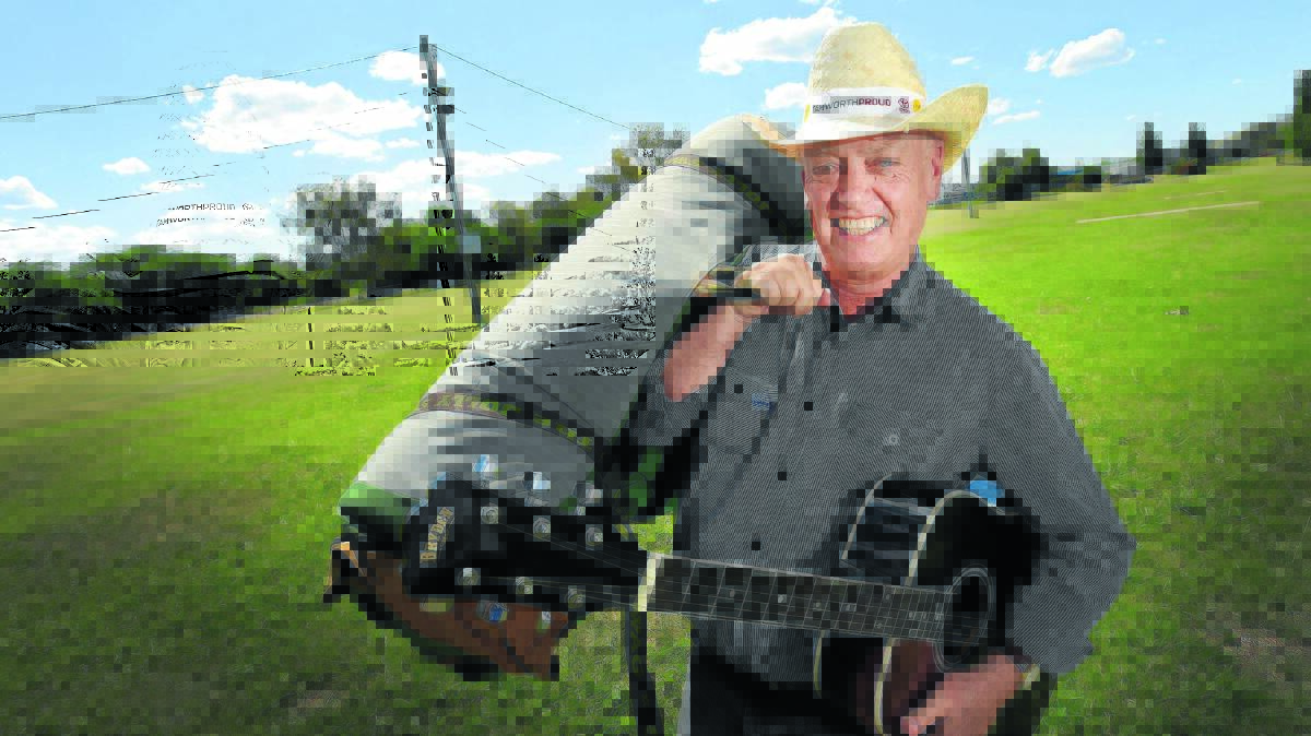 POP-UP ACCOMMODATION: Barry Harley gets comfortable with a guitar and a swag at the new Tamworth Country Music Festival camping area at Cross Park.  Photo: Gareth Gardner 231115GGC05