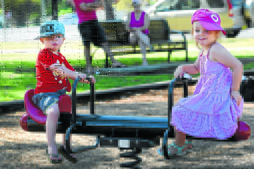 UPS AND DOWNS: Brayth (2) and Taylor (4) Townsend played on the see-saw at Anzac Park. Photo: Gareth Gardner 051015GGA03