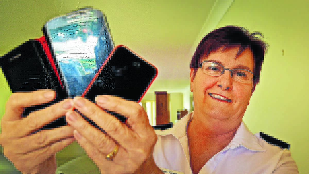 out they go: Major Cathy Rogerson from the Tamworth Salvation Army wants the community to recycle their old phones to help out the Salvos. Photo: Geoff O'Neill 291215GOC01