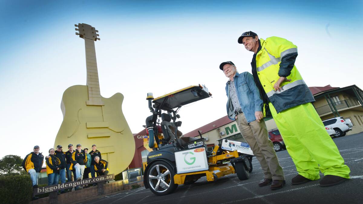 I get Around: Ride to The Other Side mower man Craig Alford at the Big Golden Guitar with country music legend Rex Dallas after the pair cut into town as part of a 
charity mow around the country. Photo: Barry Smith 110615BSD03
