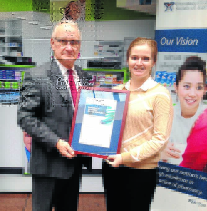 OUTSTANDING RESULT: UNE celebrated another positive chemical reaction when student Brighid Carey received the 2015 NSW Pharmacy Student of the Year award from Pharmaceutical Society of Australia vice-president John Chapman.