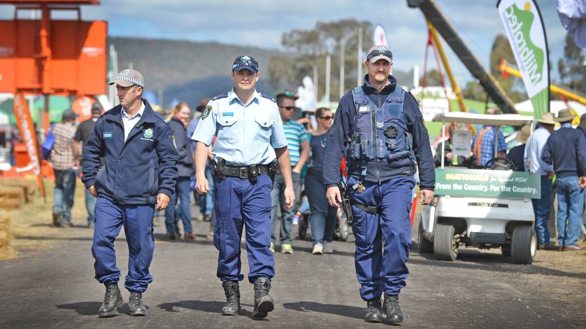 FOOT PATROL: From left, Oxley police Senior Constables John Brown and Brett Thomas, with Sergeant Damian Wood walking the beat at AgQuip. Photo: Barry Smith 180815BSA40