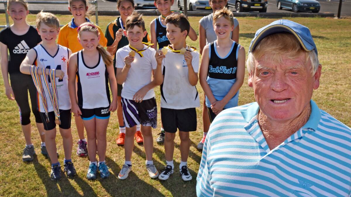 Wally Warner stands proud in front of ten of his chargers who are off to the state championships as the veteran running coach calls it a day after 50 years on the track. Photo: Geoff O’Neill 071015GOD01