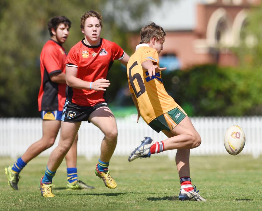 Warialda’s Zac Parker moves in to tackle Scone’s Nathan Clerke (kicking) during recent GNA trials. Parker was named in the 41-strong GNA intake and has an  induction at the Tamworth Sports Dome on Saturday.  Photo: Barry Smith 101015BSH15