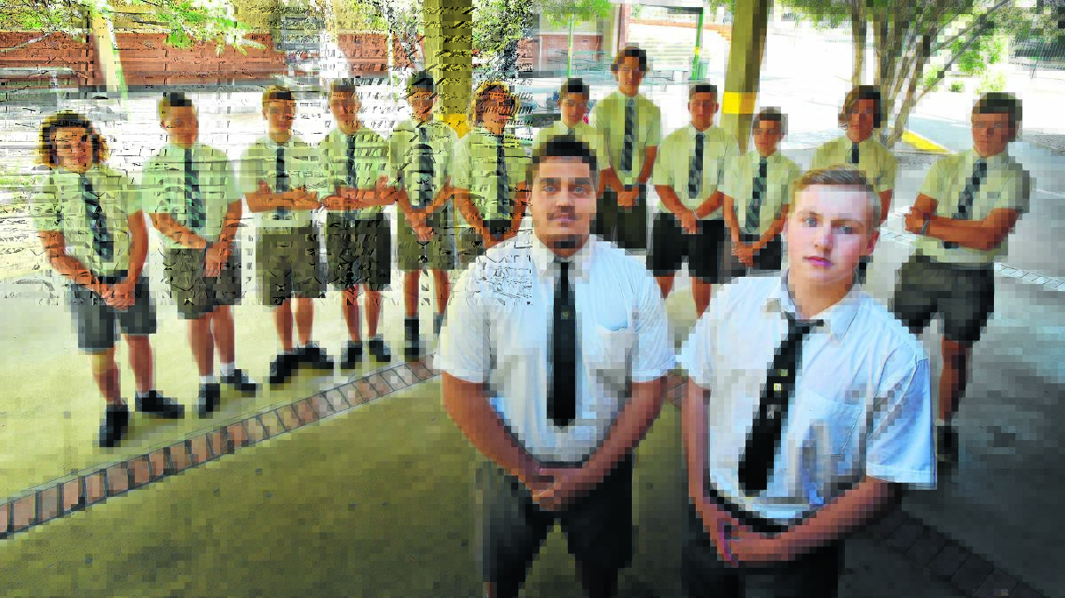 SUPPORTING CHANGE: White Ribbon ambassadors, front from left, Tyson Waters and Daniel McCulloch with the rest of the school’s White Ribbon Committee. Photo: Geoff O’Neill 091015GOB01