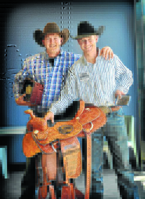 Ty Parkinson and Luke Morgan (right) celebrate their World IPRA rodeo titles on arriving home at Tamworth 
Airport yesterday. Photo: Paul Mathews 200116PMG15