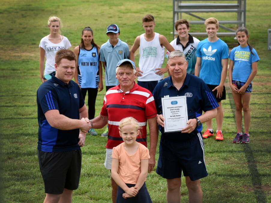 Ricky Craig (left) congratulates Wally Warner on his Sportsmans Warehouse Volunteer Award with Bob Barber and Damikah Barwick-Taylor (front) while some of Warner’s troupe look on.  Photo: Gareth Gardner  311015GGB01