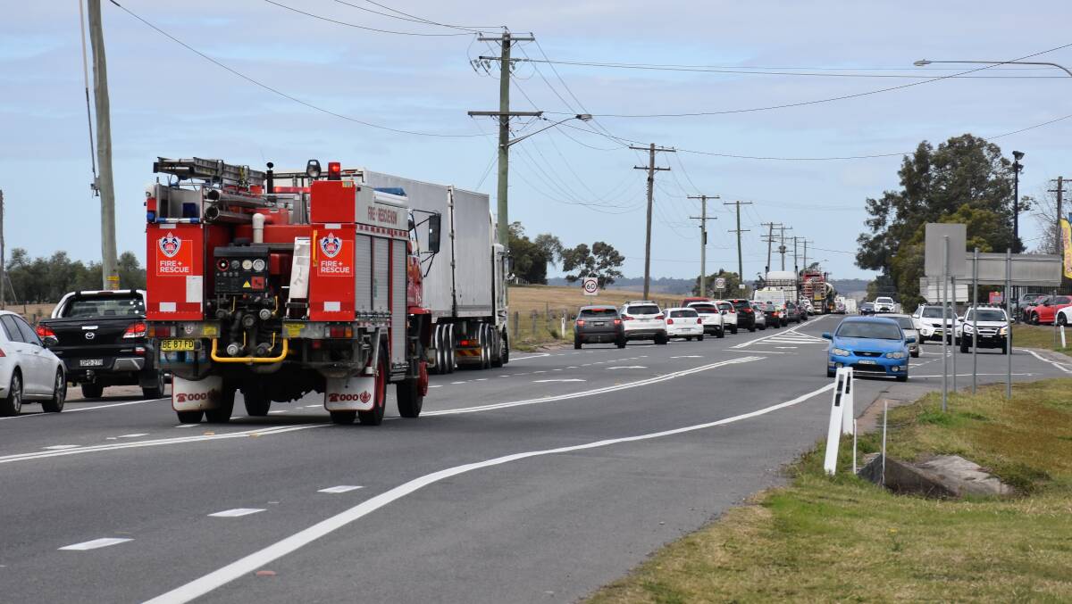 Road closed: Emergency services at the crash site on Friday morning. Photo: Singleton Argus