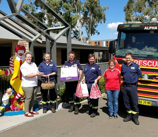 CHARITY: Ronald McDonald House Staff Kelly McCrohan and Debbie Herdegen with Tamworth firefighters this week. Photos: Supplied