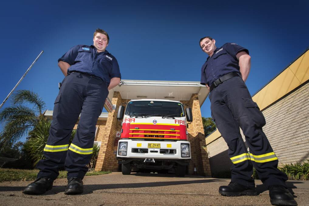 WE'RE OPEN: Dylan Chester and Jason Lee of West Tamworth Fire Station invite you to the open day on Saturday. Photo: Peter Hardin 160517PHA27