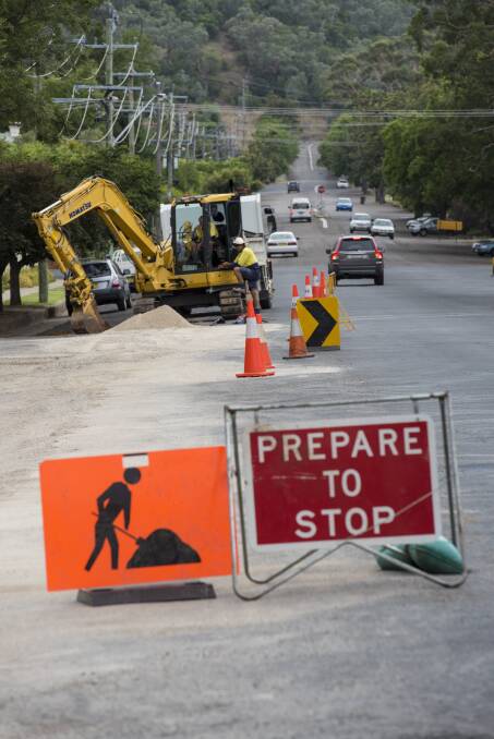 UNDERWAY: Work to water mains and road surfaces in White St is underway and is expected to be completed by Easter. Photo: Peter Hardin 170216PHC01