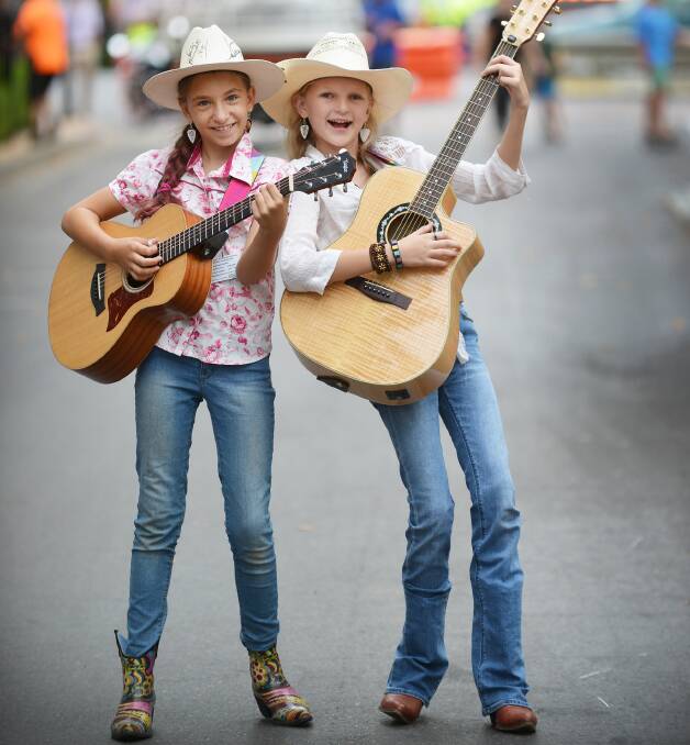 IT'S BEGUN: Friends Felicity Kircher, 11, from Brisbane and Phoebe Jay, 13, from Brisbane, were among the buskers in Peel St last year. 150116BSA10