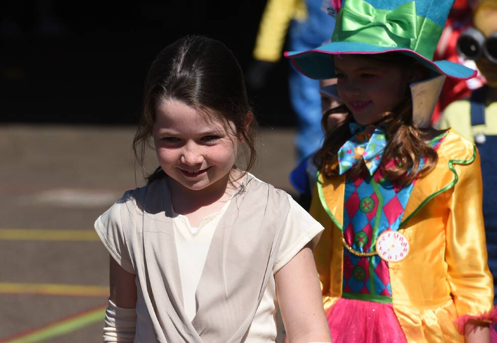 ALL SMILES: Maeve Black and Halle Swan joined in on the Book Week parade at school. 240817GGB03