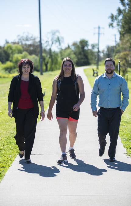 STEPPING UP: Staff member Tammy McAuliffe with Jamie Lee Hughes and Challenge Deputy CEO Stephen Doley. Photo:Peter Hardin. 181016PHD20