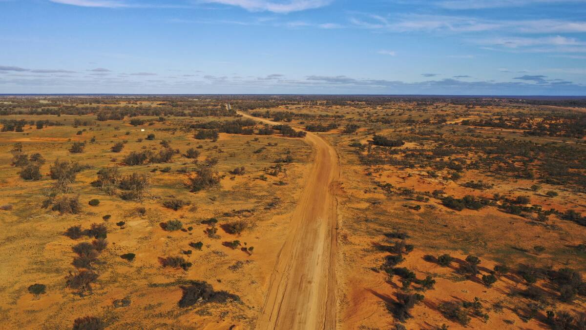 A bird's eye view captures the loneliness of the outback road.