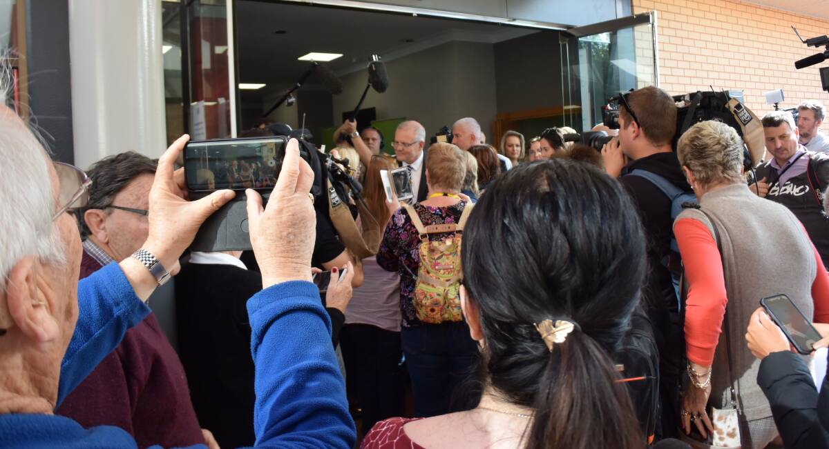 CWA VISIT: Media, delegates and spectators strive for a glimpse of Prime Minister Scott Morrison as he leaves the NSW CWA state conference at Albury Entertainment Centre.