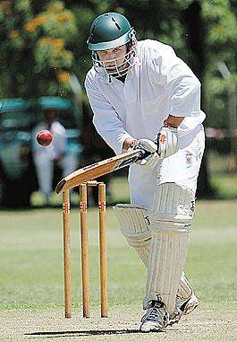 Fly byes: City United batsman Darren Schieb conjures up all his cricketing concentration to ignore the flies swarming around his helmet at Scully Park on Saturday. Now the recent plague is threatening sheep flocks. Photo: Robert Chappel 121105RCB06