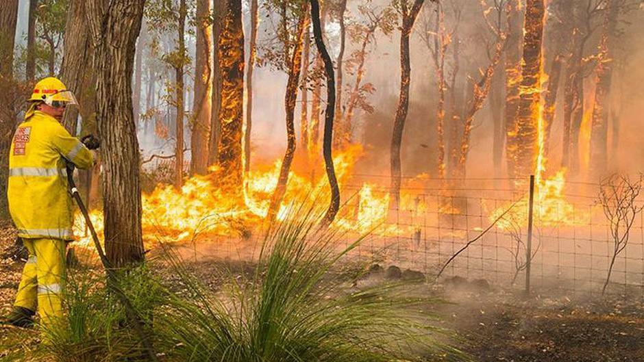 A bushfire burning out of control in the Perth hills has claimed one life and 52 homes. Pictures: DFES and Channel 10