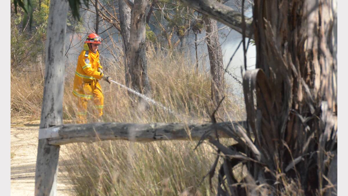 BURNING: Fire fighters were quickly on the scene to contain the fire, which burned close to the nearby brick dwelling. Members of the Rural Fire Service, Inverell Fire and Rescue and Inverell Police attended the blaze.