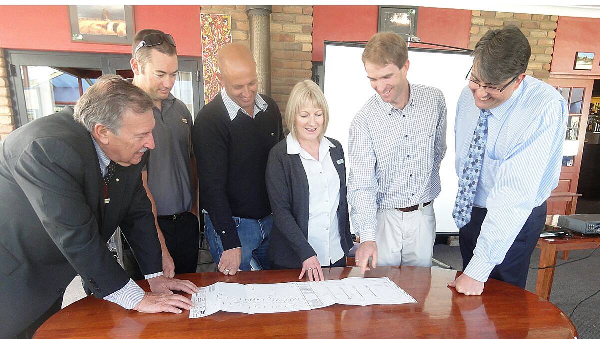 BIG IDEAS: From left, Guyra mayor Hans Hietbrink, Essential Energy’s Mark Vaughan, council engineering project manager Ned Mozell, New England Mutual’s Sue Young, council engineering director Ben Harris and council general manager Ben Cushway look over the plans.