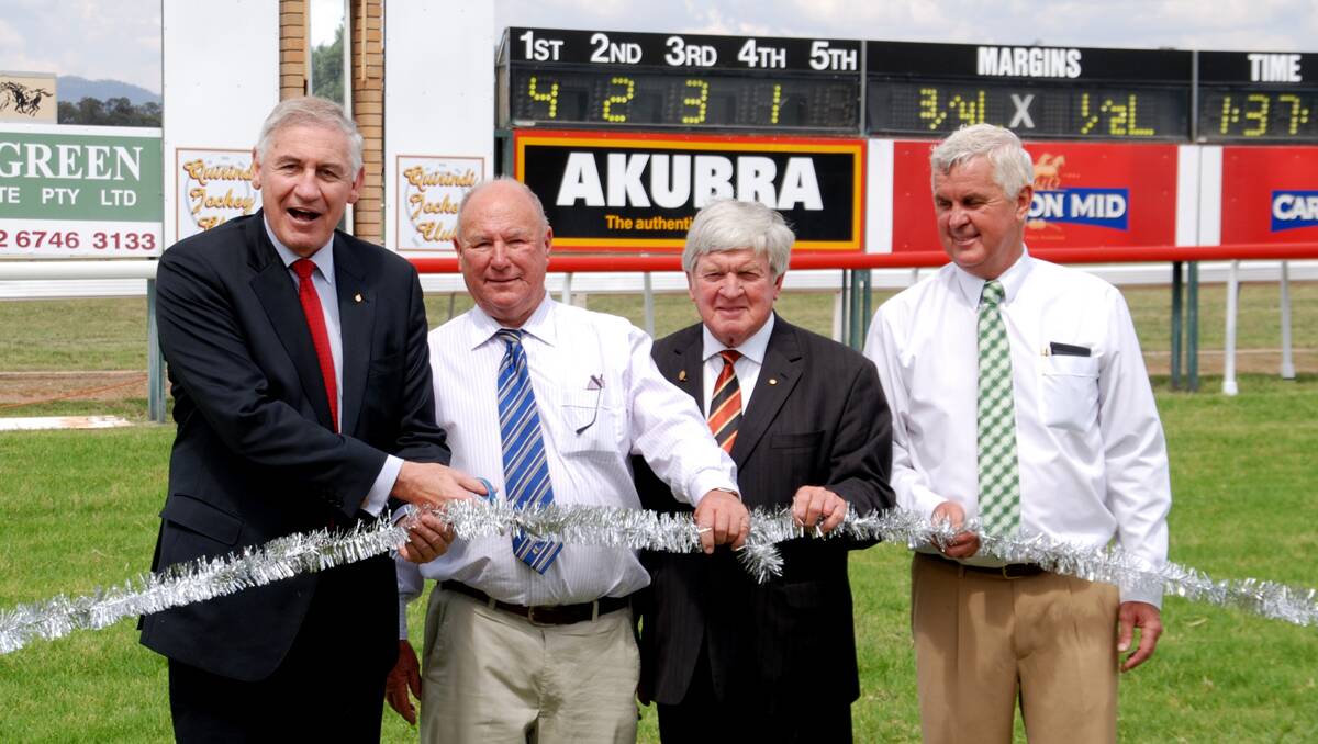 MP George Souris (left) officially opens the new plastic running rail at Quirindi Racecourse with the help of (from left) Ted Wilkinson (QJC secretary), Ian Lobsey (Liverpool Plains Shire mayor) and Jeff Galbraith (QJC president). Photo: Geoff Newling 081212JA05