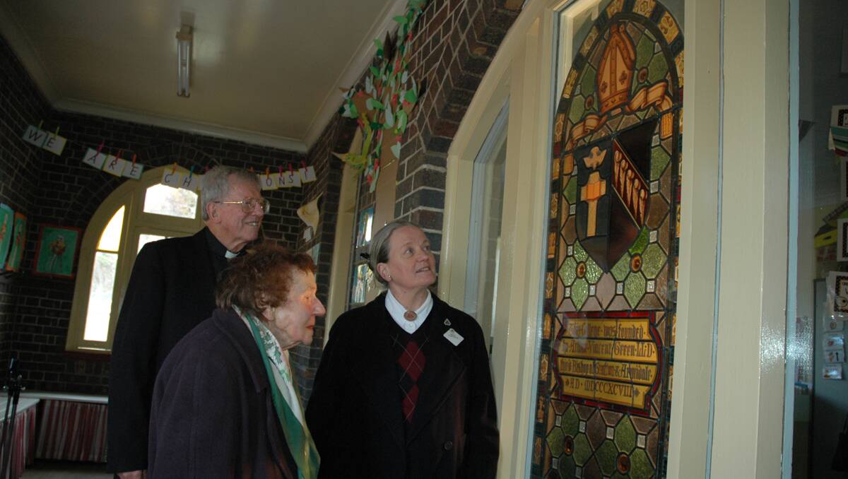HOME AT LAST: Reverend George Garnsey, NEGS Old Girls’ secretary Juliet Cameron and archivist Jean Newell were delighted to see the historic stained glass window back in place at the former St John’s Theological College, Armidale. 