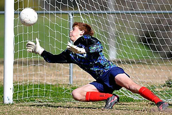 Oxley goalie Toby Fox was one of the game’s heroes after he saved twice  during the penalty shootout.Photo: Grant Robertson. 240712GRB23