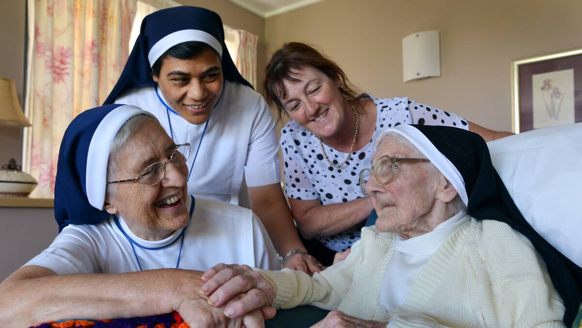 TIME FOR CAKE: Sister Arcadius, Sister Paula and Nazareth House general manager Belinda Mears wish Sister Ursula a happy 102nd birthday. Photo: Barry Smith 270213BSE02