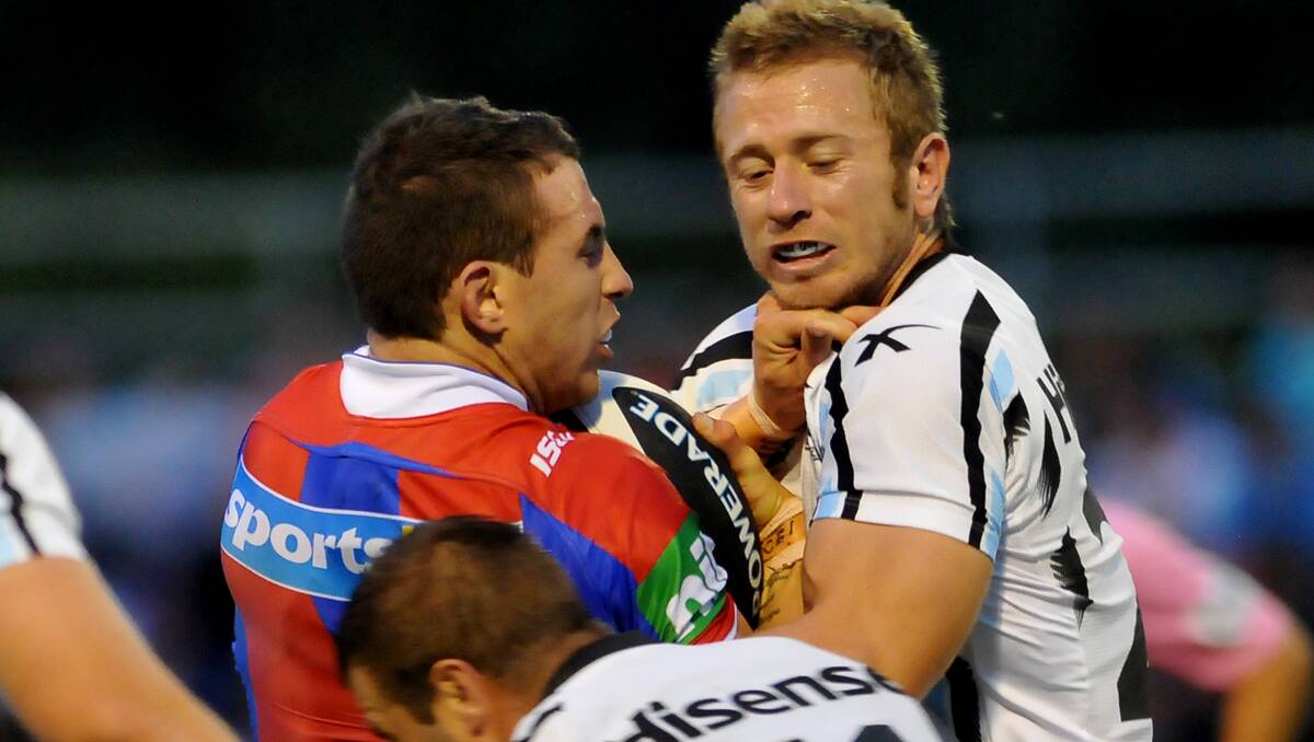Cronulla winger Nathan Stapleton confronts Knights fullback Darius Boyd in Saturday’s trial. Soon after he was carried off in a daze. 230213GRD10