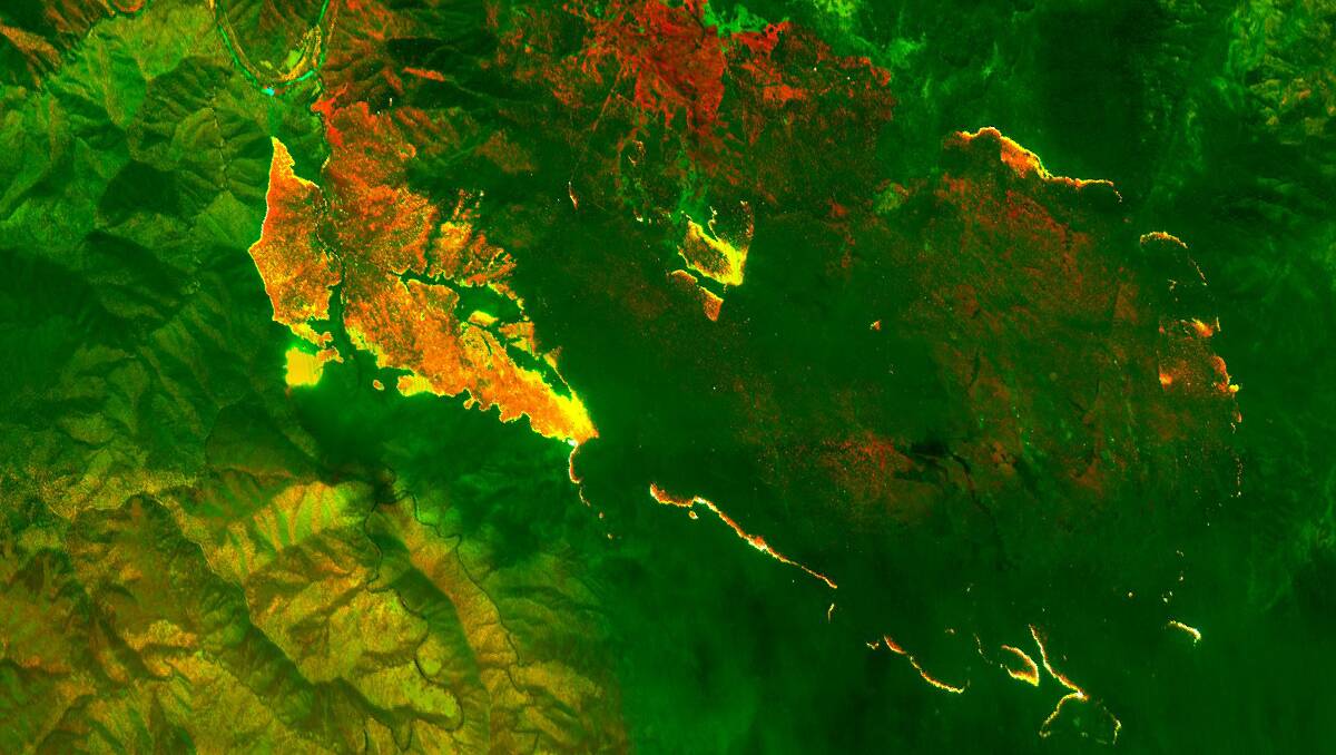 INSIDIOUS GLOW: An infrared image of the fire called Georges Junction (each fire is assigned a name) in the Oxley Wild Rivers National Park that has already burnt out a massive 14,000 hectares and is likely to join up with the Freds Creek fire. The active edge of the fire shows up bright yellow; the red areas are the burnt areas. Photo courtesy New England RFS