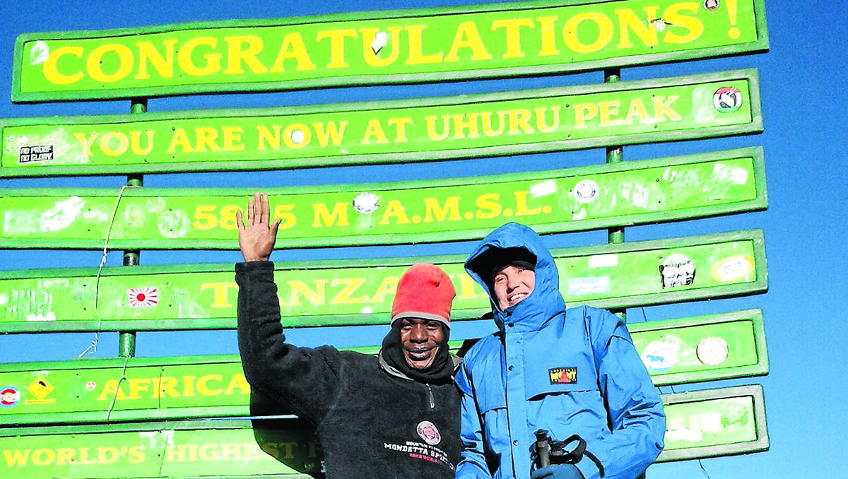 right – NO ORDINARY FEAT: Armidale vision-impaired woman Deb Warren at the Uhuru Peak on Mt Kilimanjaro with her guide, Elias.