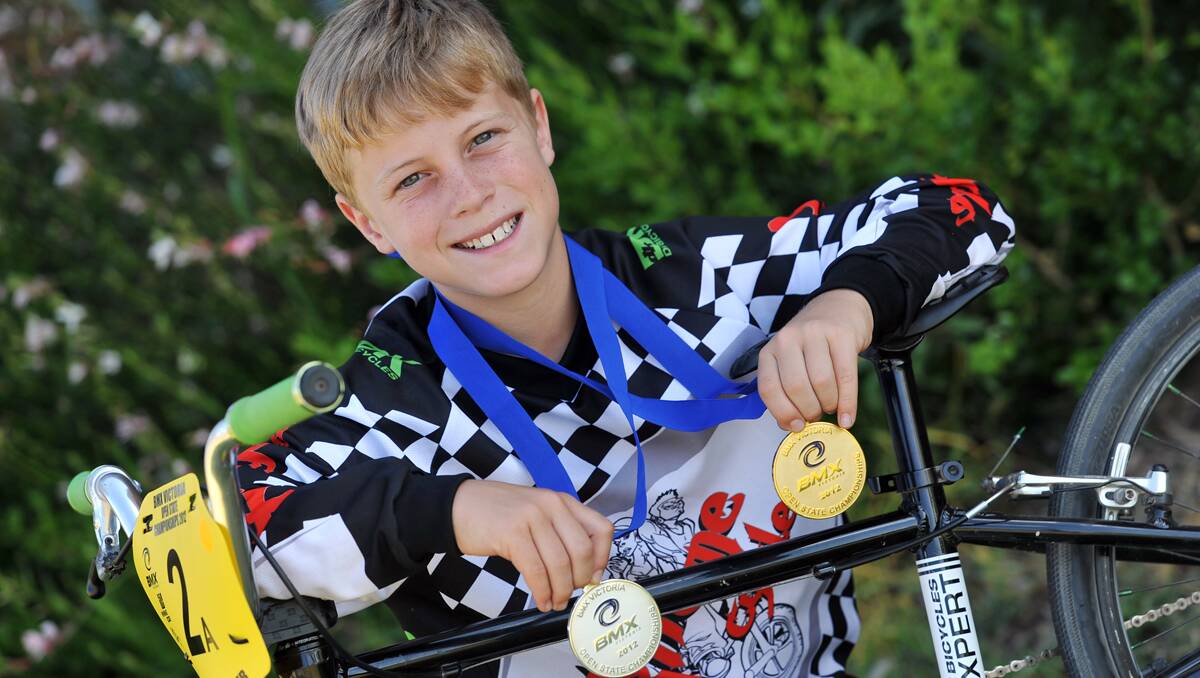 Jack Davis with his Victorian BMX State Championship gold and silver medals. Photo: Barry Smith  291112BSF04