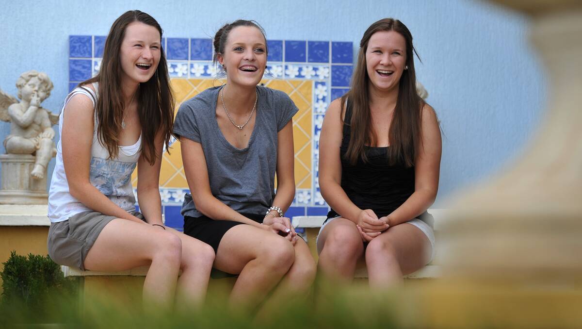 LIGHT RELIEF: Oxley High School 2012 Year 12 graduates, from left, Kahla May, Clare James and Julia Mulligan are looking  forward to a schoolies trip to the Central Coast. Photo: Barry Smith 151112BSI03 