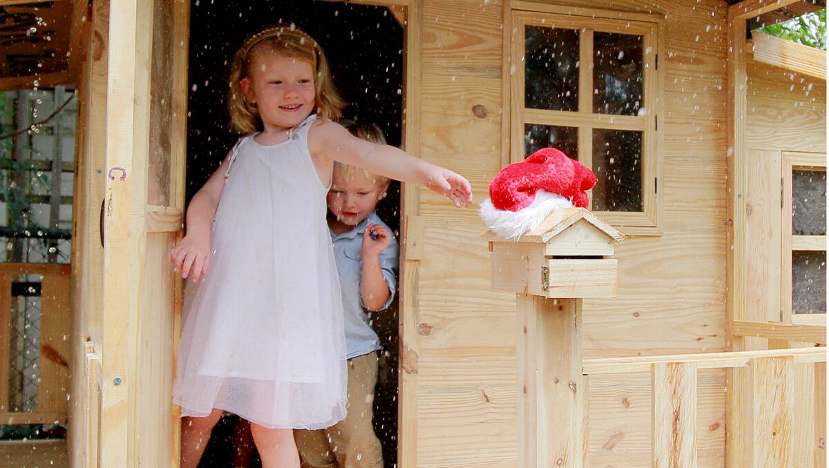 CHRISTMAS MORNING: Rain didn’t dampen the spirits of Annabel and Oliver Richards of West Tamworth who spent Christmas morning playing in their cubby house with new Christmas presents.  Photo: Robert Chappel 251212RCA01
