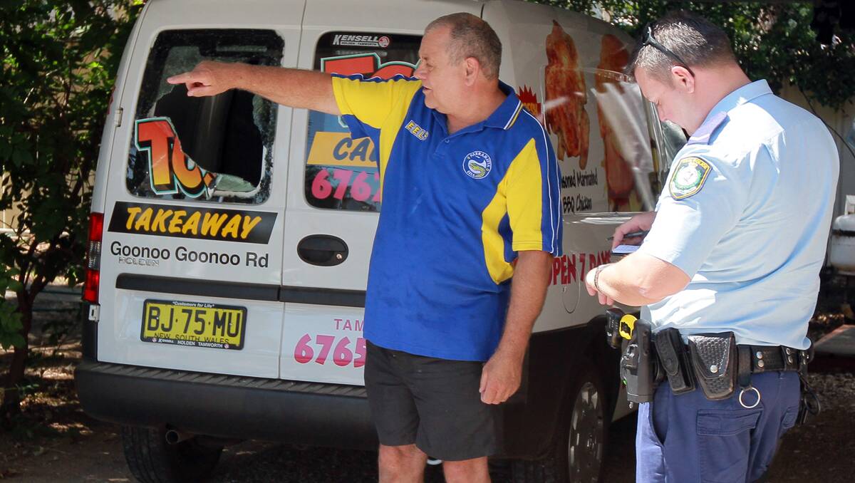 FED UP: TC’s Takeaway owner Peter Balsar talks to Tamworth police about the latest incident. The van’s broken window can be seen in the background. Photos: Robert Chappel 100113RCA015