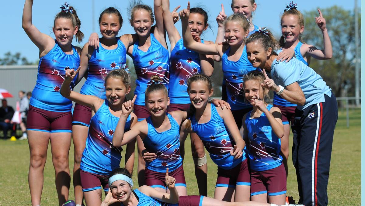 MacKillop celebrates it State PSSA Girls’ Touch Carnival success with coach Joanne Wong yesterday. Photo: Gareth Gardner  150813GGD16