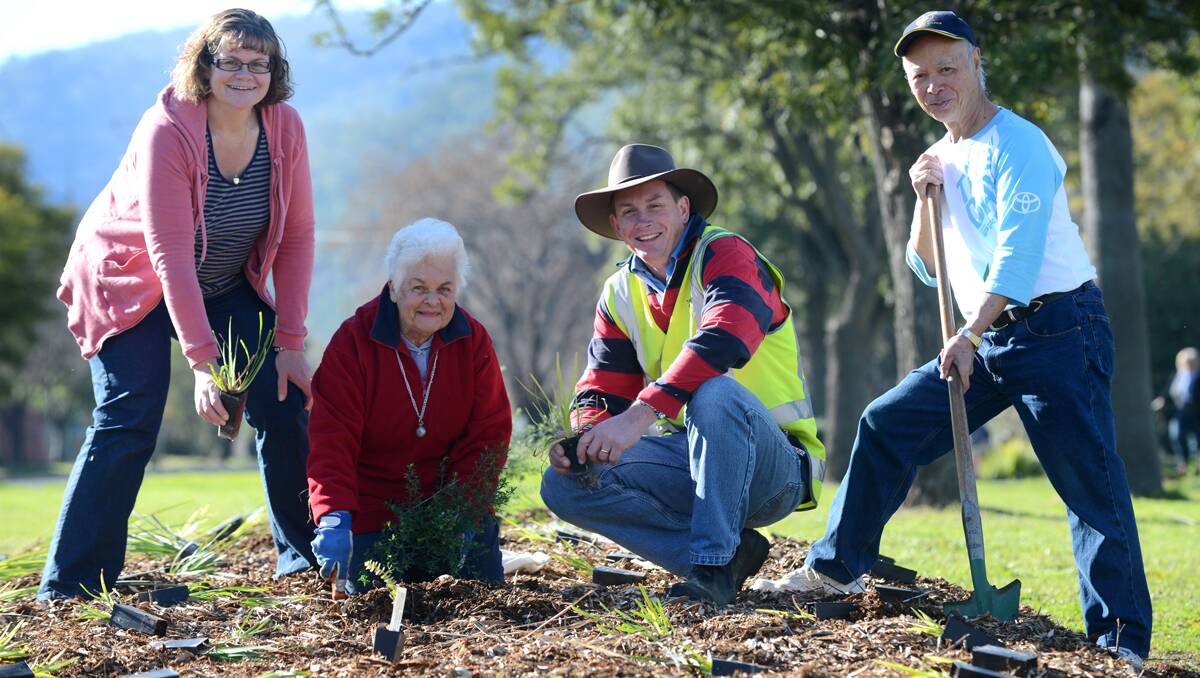 NATIONAL TREE DAY: Alison Leckie (volunteer) left, Doreen Goddard (Tidy Towns), Hugh Leckie (Tamworth Regional Council senior parks and horticulture officer) and Paul Ying (Tidy Towns chairman) do their bit by planting trees at Burgess Park in North Tamworth yesterday. 280713BSA05