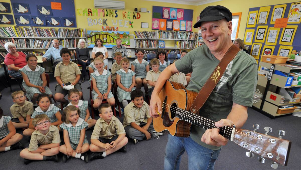 SING UP: Bushwacker's band member Roger Corbett helped write Duri Public School’s song yesterday with the school’s students. Photo:  Barry Smith 291012BSE04