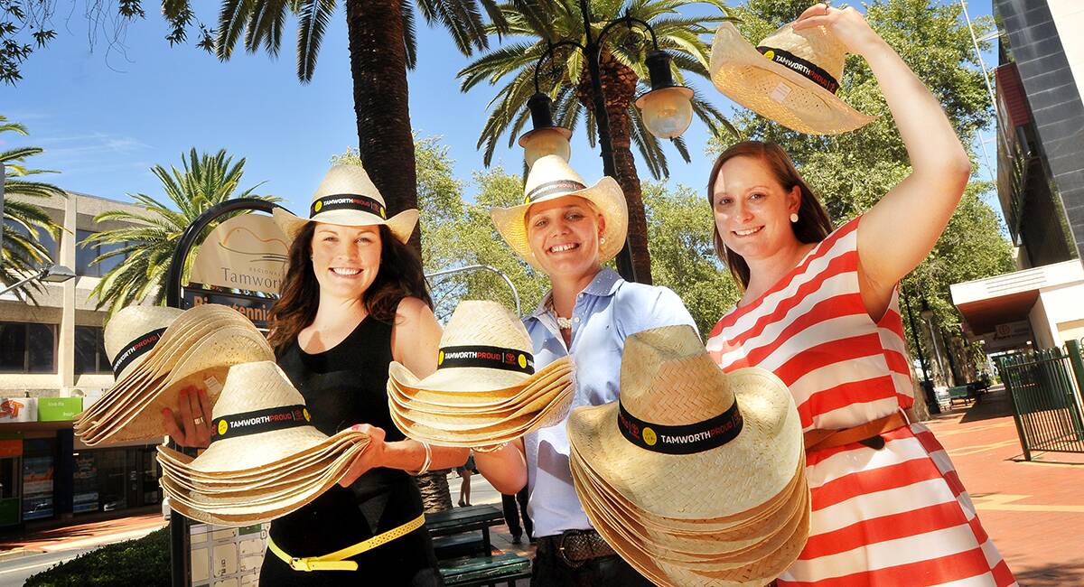 GET YOUR HAT ON: Tamworth Regional Council business and events staff Erin Chillingworth, Heidi Smith and Susie Buckland urge residents to show their festival pride. Photo: Gareth Gardner 060114GGB01