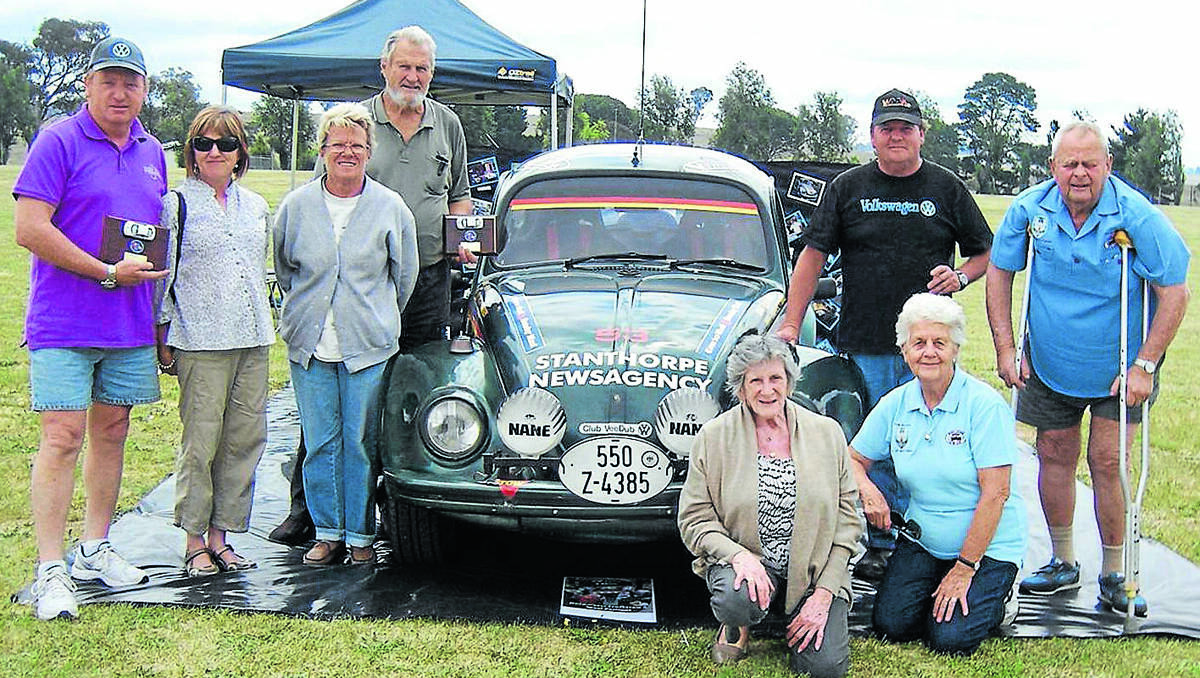 Beetle mania: At the VW Show and Shine were, standing from left, John and Judi Rosberg, Gwen and Laurie Murray, event organiser John Watt and his VW and Dave Mason. Kneeling, Eyvonne Rizzo and Pam Mason.