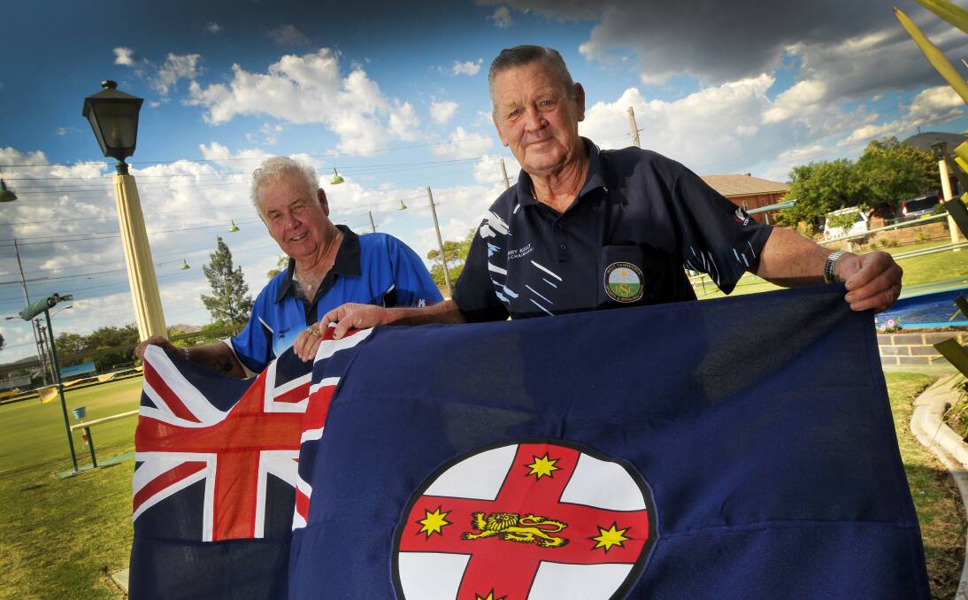 West Tamworth president Bob Hennessy (left) and vice-president Terry Kelly proudly display the club’s new State flag  on  Thursday.  Photo: Gareth Gardner 160114GGJ01