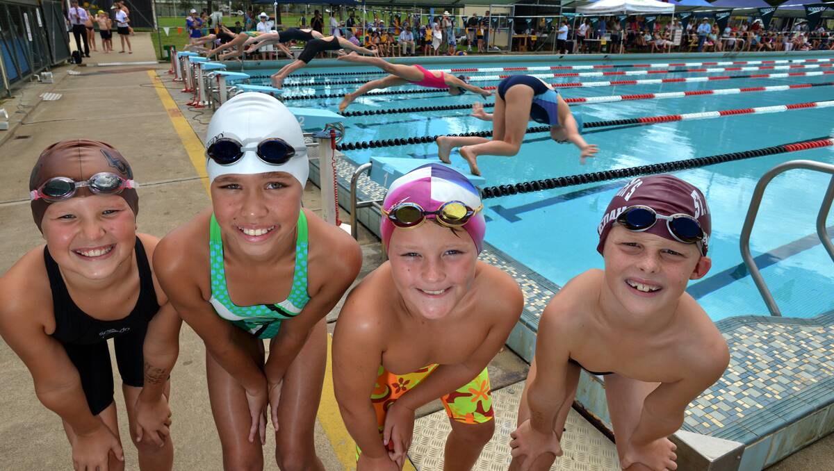 Awaiting  their next event at the Armidale Diocesan Swimming Carnival yesterday were (from left) St Joseph’s Tenterfield’s Jessica Brierley (11), St Joseph’s Glen Innes’s Satara Speedy (11) , St Edward’s Tamworth’s Kyle Short (10) and Charlie Pinn (9) from St Xavier’s Gunnedah . Photo: Barry Smith 280213BSC03