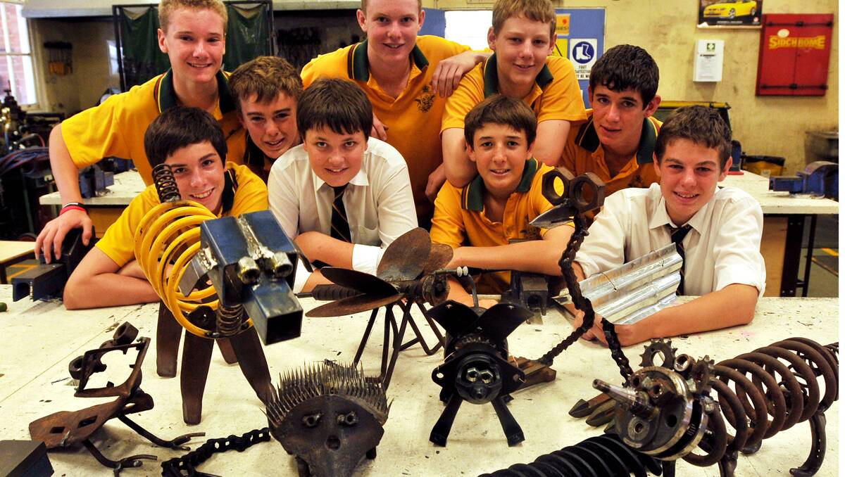 CREATIVE  CLASSROOM: Farrer Year 9 students with their recycled  metal-work.  Front row, from left, Joel Petty, Kelvin Matthews, Jordan Wolfgang-Wicks, Trent Walker. Back row, Sam Carberry, George Harwood, Tim Mitchell, James  Suttor and Brad Maxey. Photo: Geoff O’Neill 301112GOA01