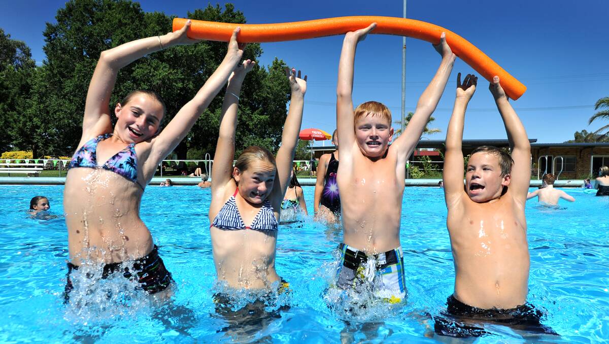 IN THE SWIM: From left, Mykenzie Semple, 11, Bronte Madden, 12, Curtis Milgate, 11, and Clay Friendin, 11, were having fun in the water at the Kootingal pool party yesterday. Photo: Barry Smith  100113BSC01