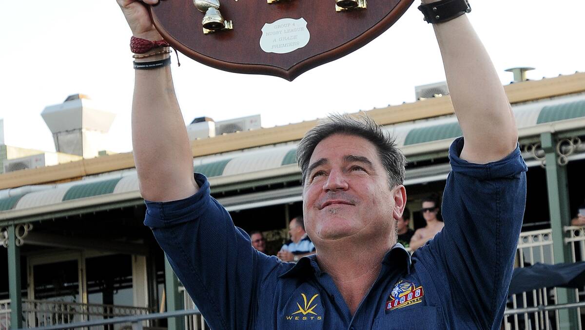 A jubilant Tony La Chiusa lifts the Tooheys Shield high after his West Lions beat North Tamworth to win a fifth successive Group 4 first grade premiership at Scully Park last month. Photo: Gareth Gardner  080913GGD32