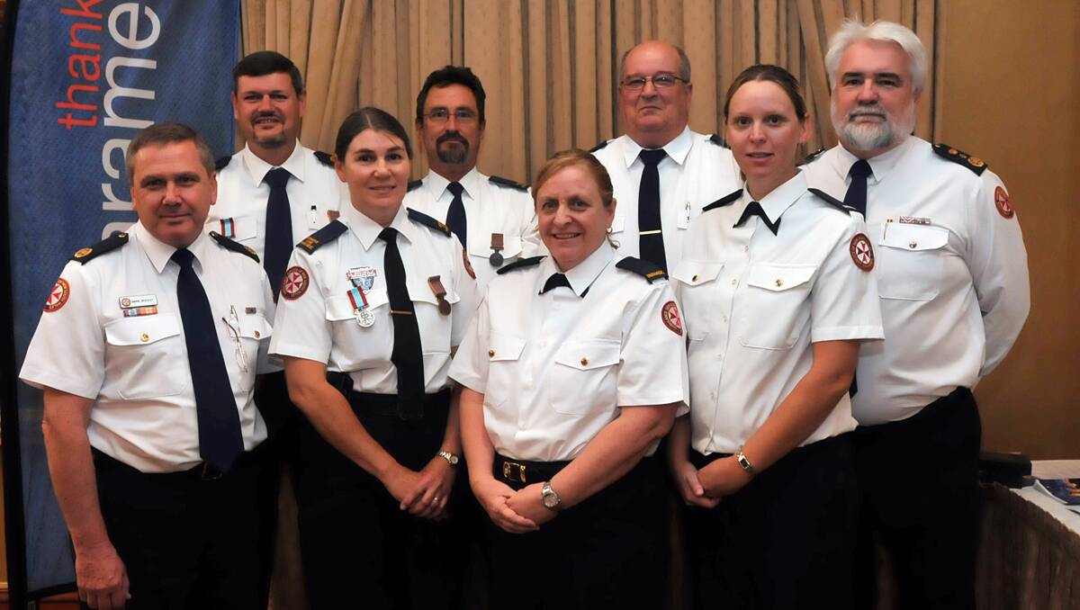 SHOWING OUR GRATITUDE: Long-serving northern region paramedics were yesterday recognised for their years of service to the community. Back from left, Tim Collins, Robert Wales and Ray Tait, and front from second left, Kerry Trow, Lisa Mackay and Kristy Emery, with Assistant Commissioner Mark Beesley, left, and Deputy Commissioner Ken Pritchard, right. Photo: Geoff O’Neill 211112GOA01